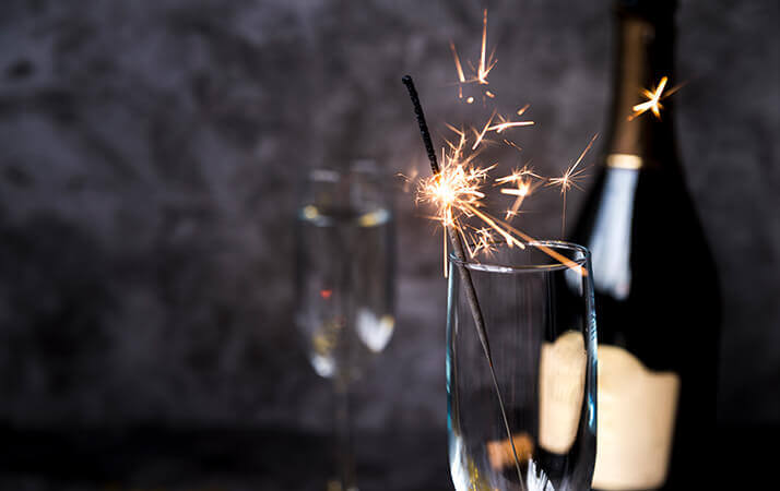 Burning sparkler with wine glass